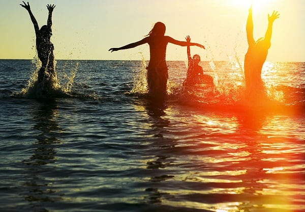 Travelling friends playing in the sea