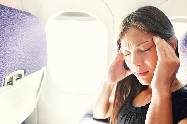 Woman with travel sickness on flight