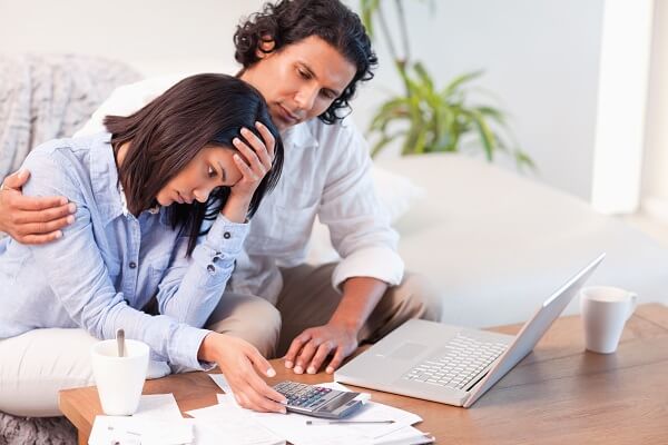 Couple stressing using laptop